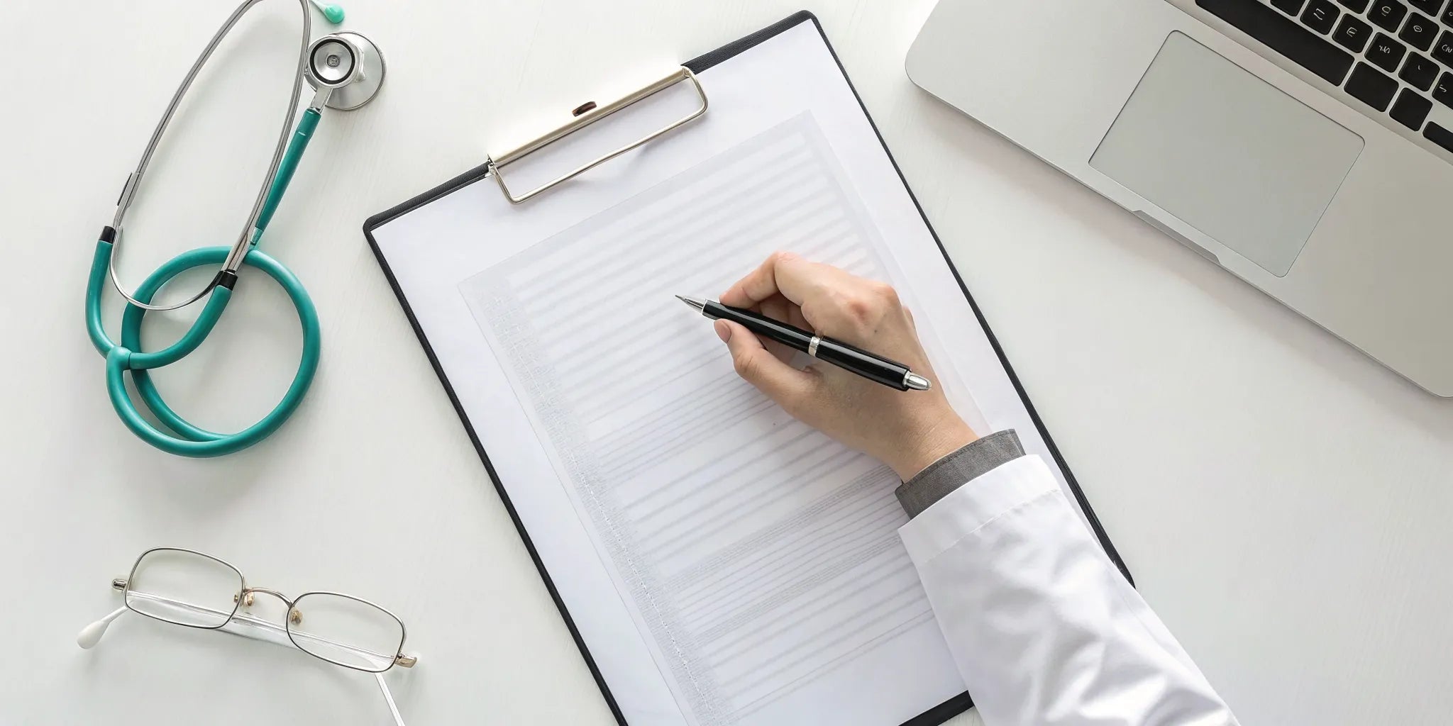 A doctor in an office writing a letter of medical necessity.