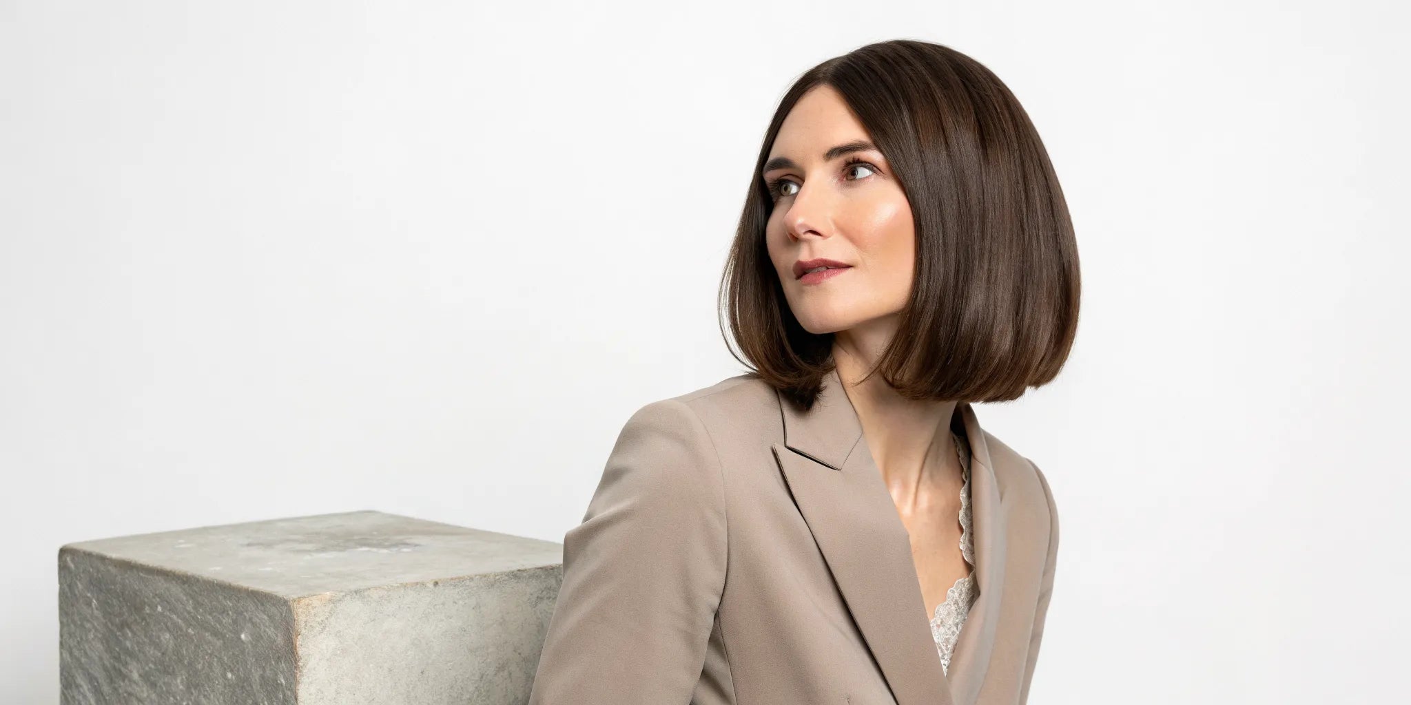 A woman wearing a natural-looking Remy human hair wig styled in a sleek brown bob.