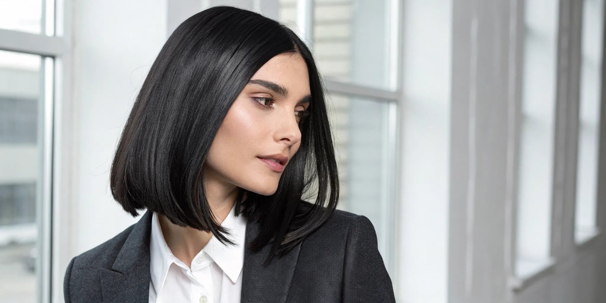 A sleek black human hair wig with a natural hairline, styled in a straight bob.