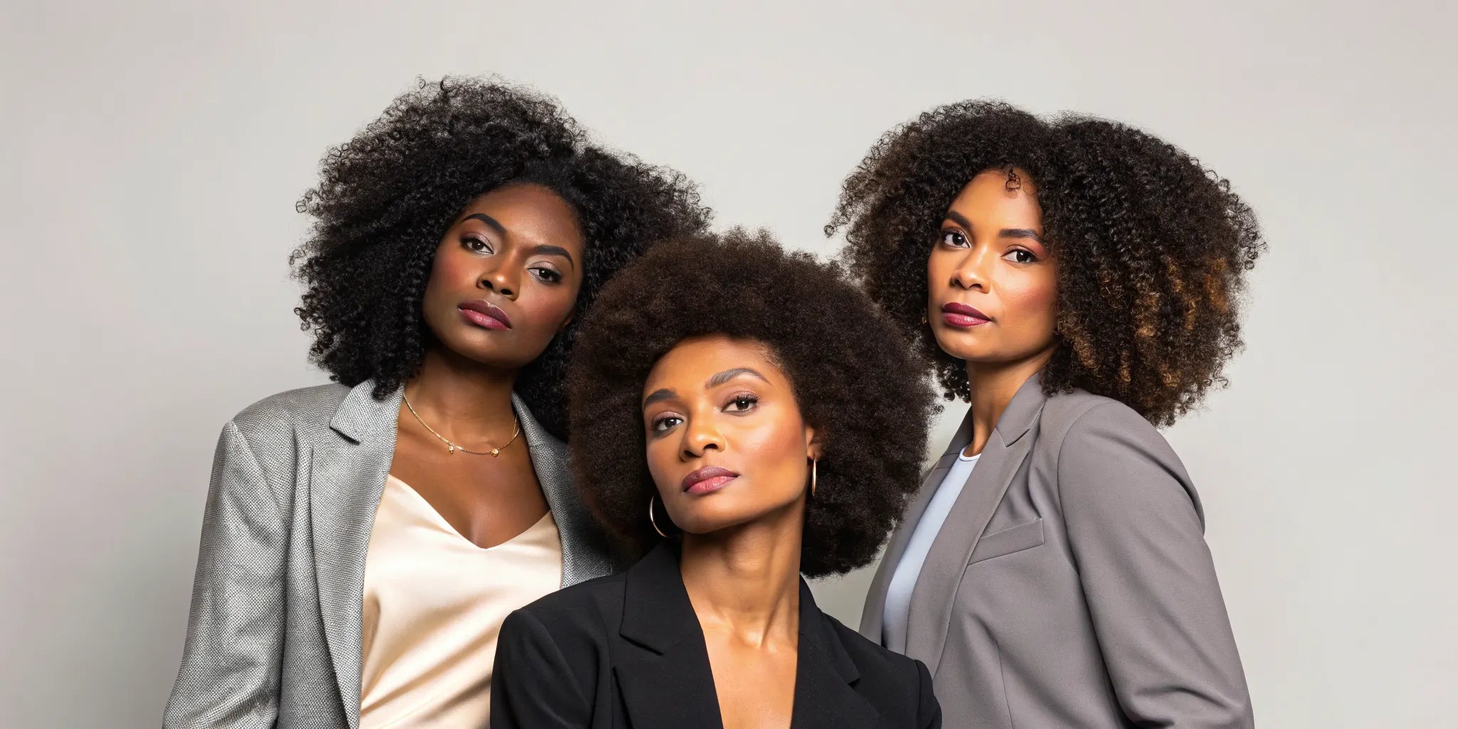 Three women wearing stylish, natural-looking afro human hair wigs.