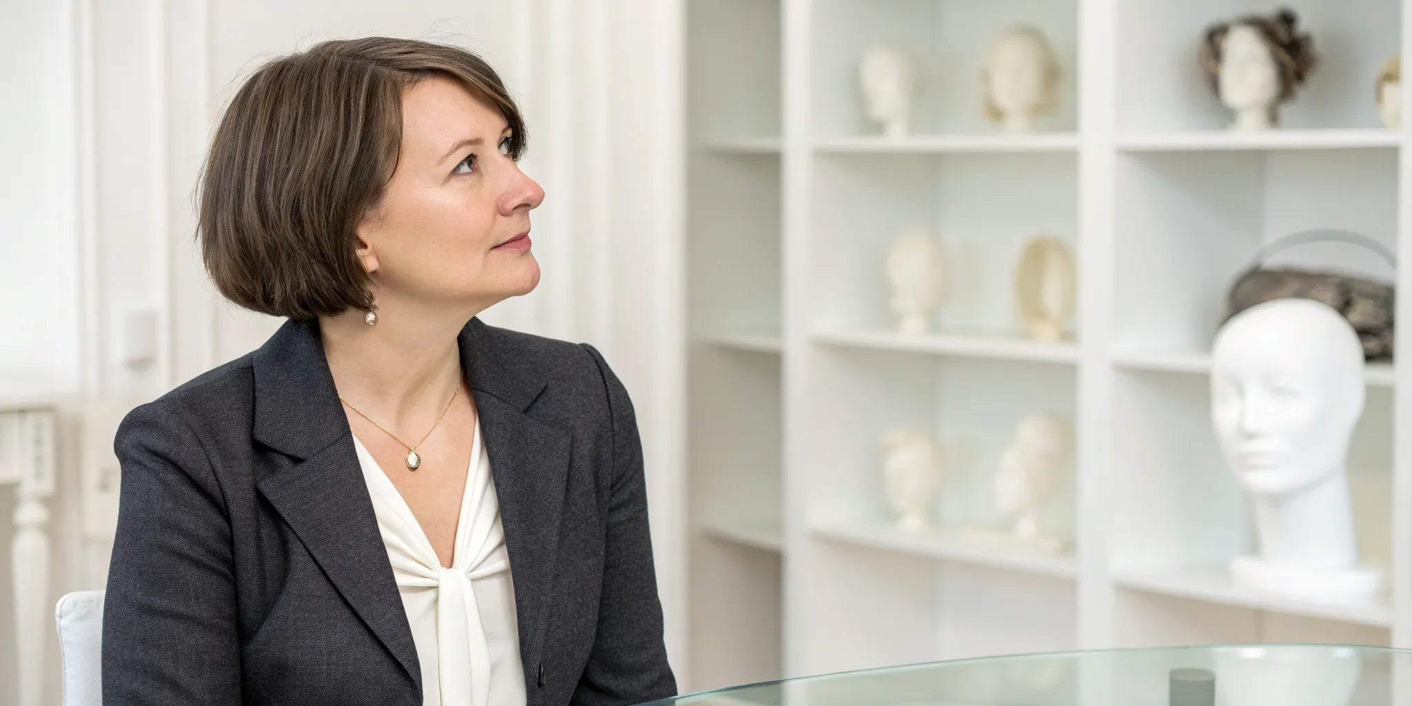 A woman choosing a short wig for women during a medical wig consultation.