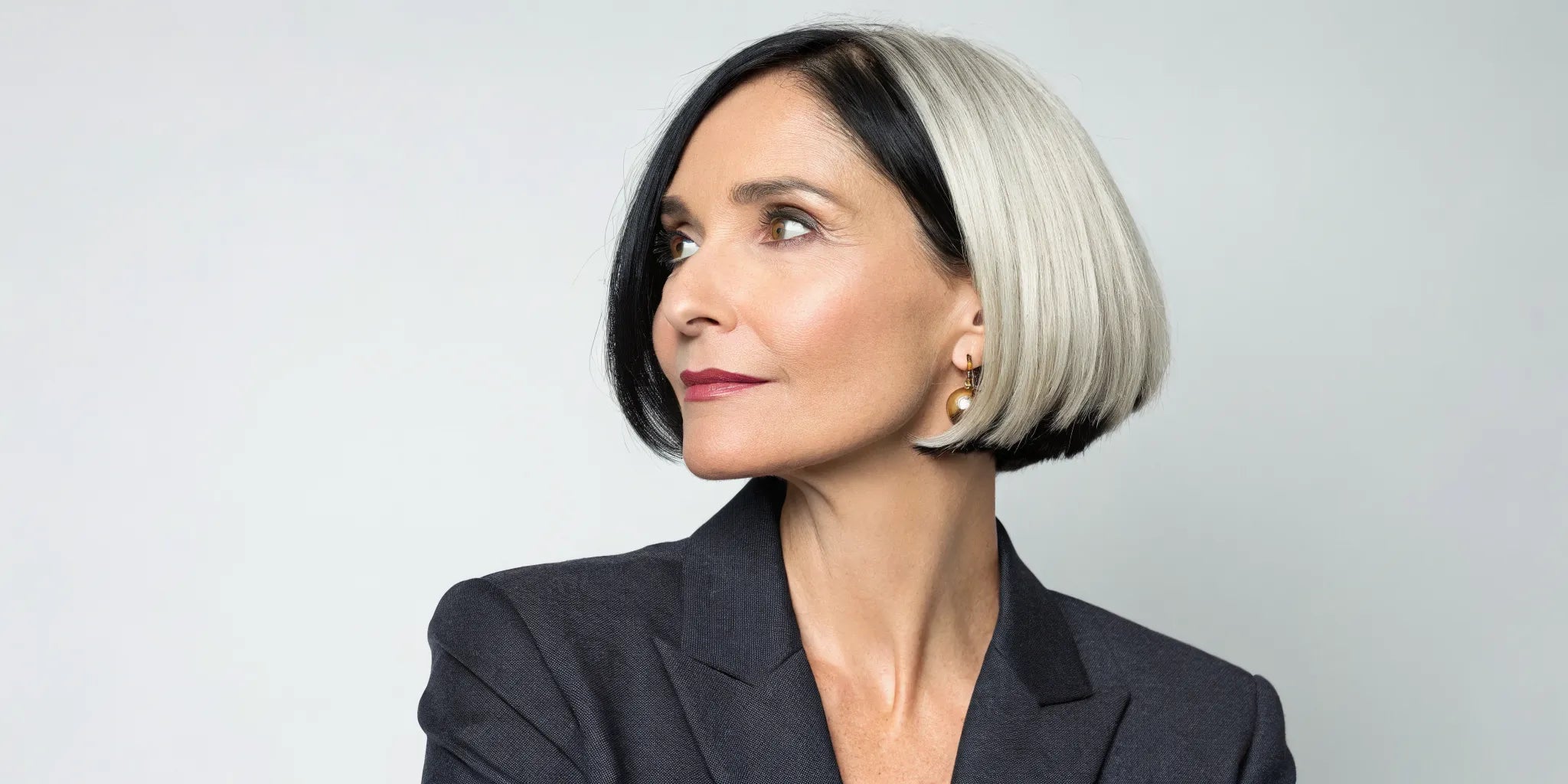 Woman wearing a sleek, modern bob wig with black and silver tones.