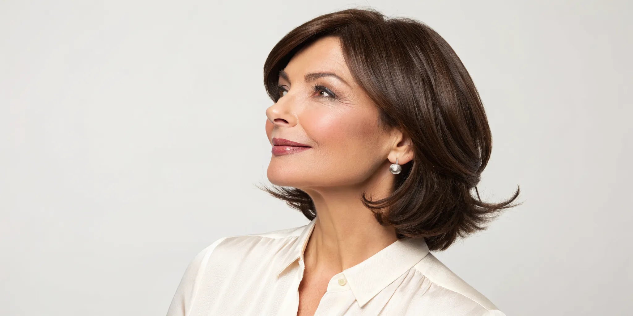 Woman wearing a short brown wig held securely in place with a comfortable wig grip.